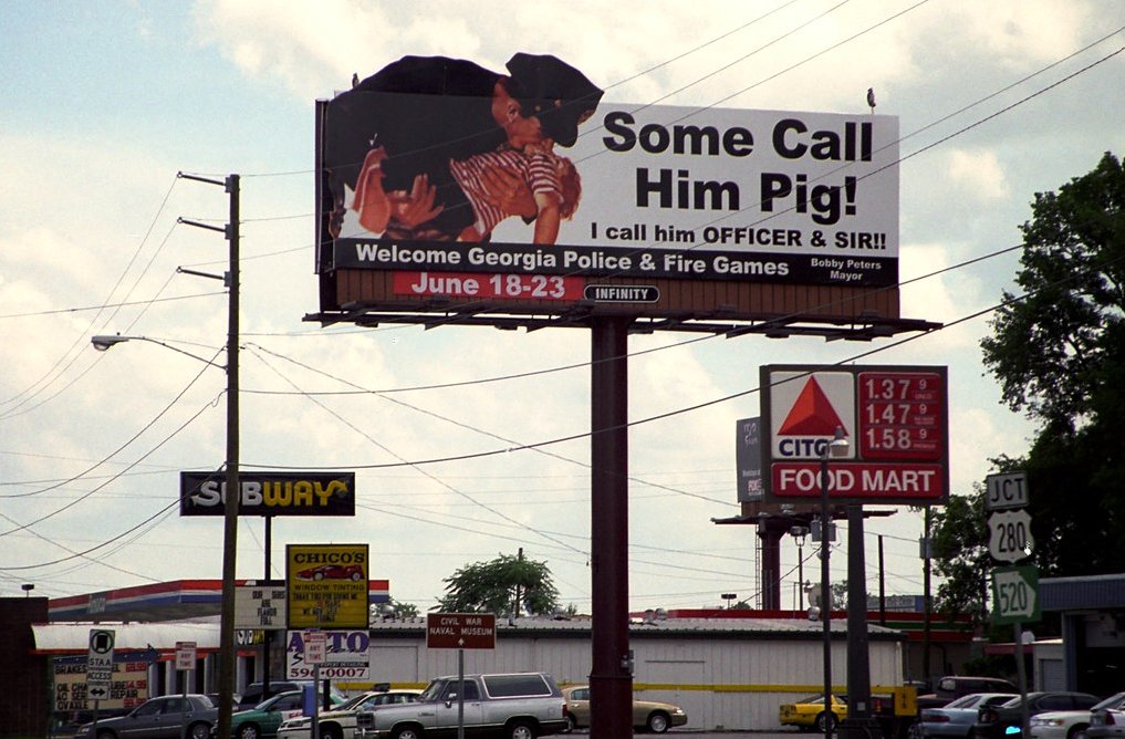 Billboard of a Cop Kissing a Kid